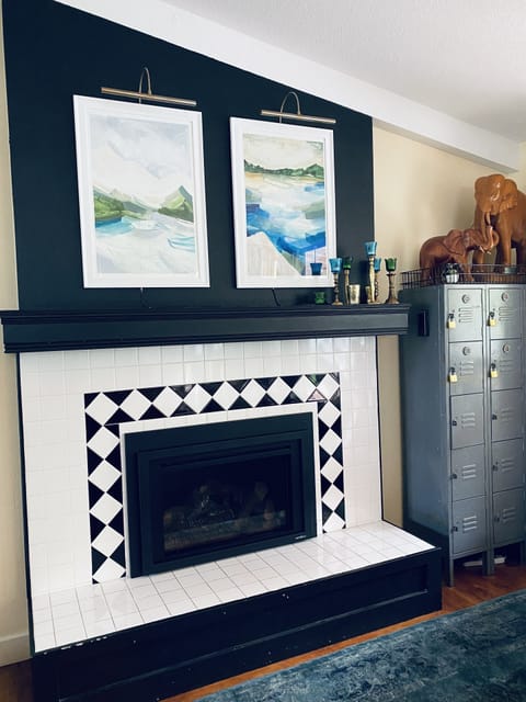 Gas fireplace with beautiful paintings by local artist Lindsey Gilmore.
