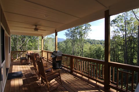 The main level porch with dining, gas grill, and hot tub
