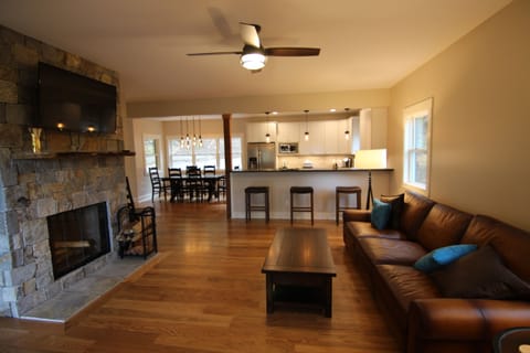 The living room with 49" Roku TV, Sonos music system, and wood burning fireplace