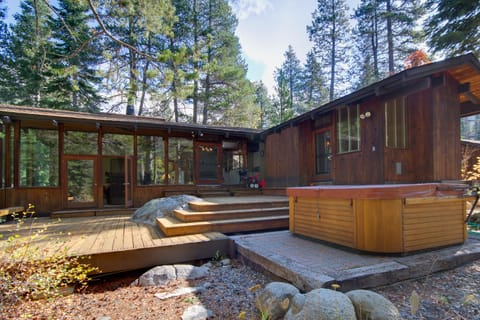 View of 2 wings of the house, large two level deck, and 8 person hot tub