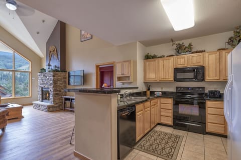 Kitchen has all major appliances, cooking supplies, microwave, and coffee maker.