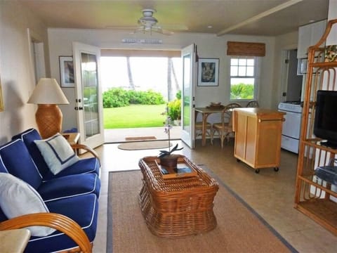 Living room opens to dining patio overlooking the ocean