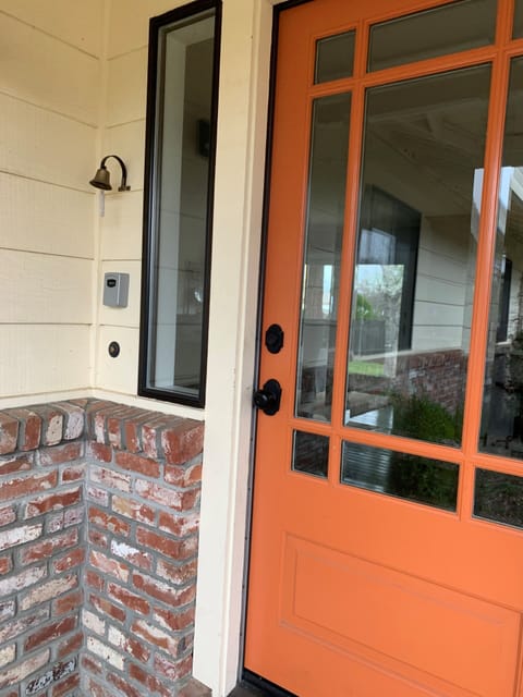 Single key to unlock both front door locks mounted on wall just left of the door