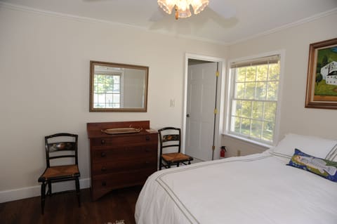 Bedroom with queen bed, antique dresser, view of garden