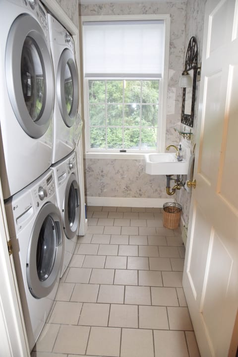 Downstairs half bath with two washers and dryers