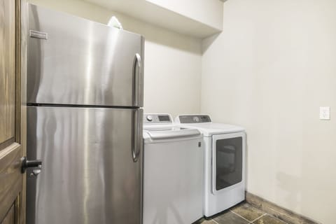 Laundry room with extra fridge on lower level