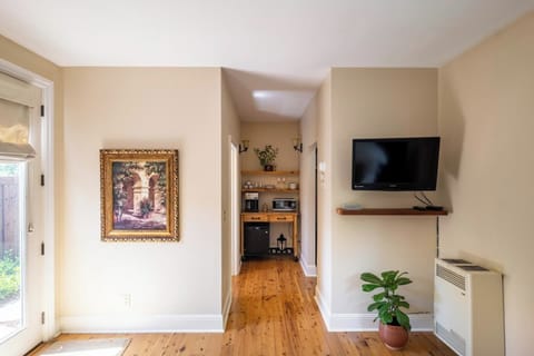 View from bed and chairs, coffee nook, closet and work space to right, bathroom to left.