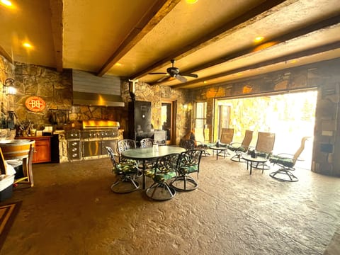 Indoor Patio Grill Area with garage style patio door to outdoor patio & firepit