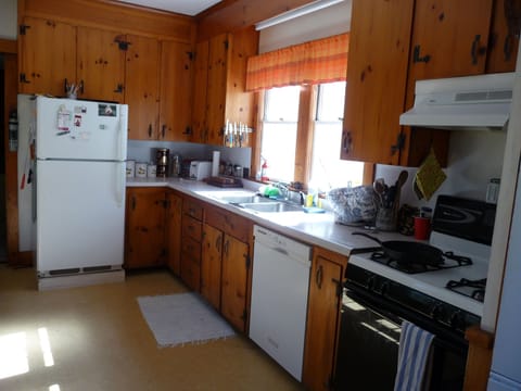 pine paneled kitchen, gas stove, dish washer, washer dryer.