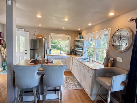 Fully Stocked Kitchen. Island with oven and seating for 2