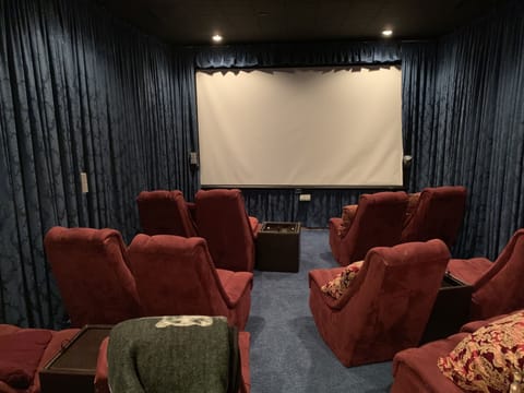 Media room with 8-foot movie screen, DVD player and dozens of DVDs, satellite TV