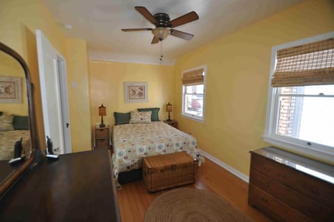 The queen bedroom with refinished wood floors,vintage dresser and walk-in closet