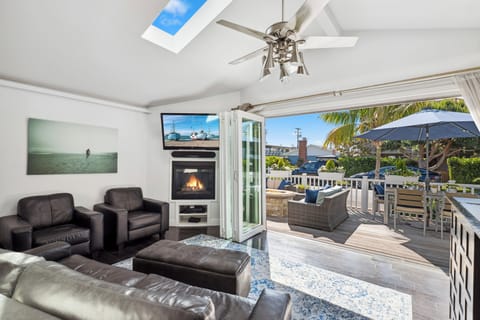 Open living room and deck with accordion doors, creating an indoor/outdoor space