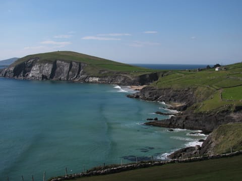 view of Dunmore Head from Slea Head,  the house is above the beach