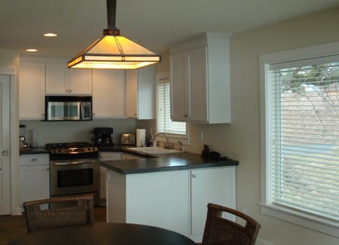 All stainless appliances in well-equipped kitchen with views!