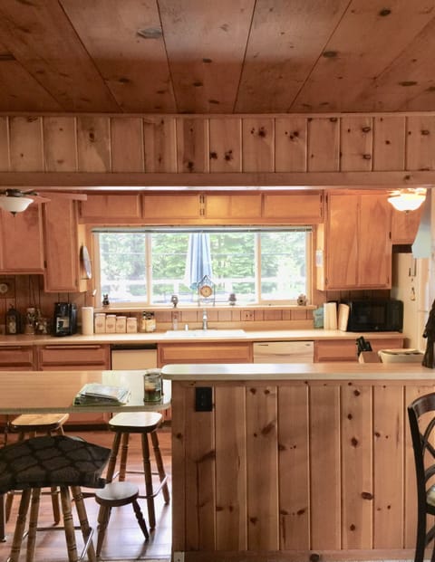 Kitchen window overlooking outdoor 2nd story balcony