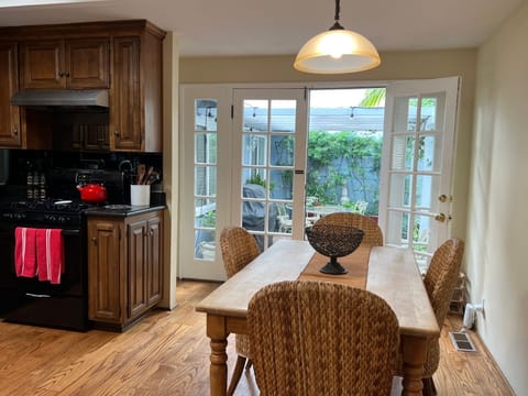Dining area off kitchen, view thru French doors to private courtyard w/ gas BBQ.