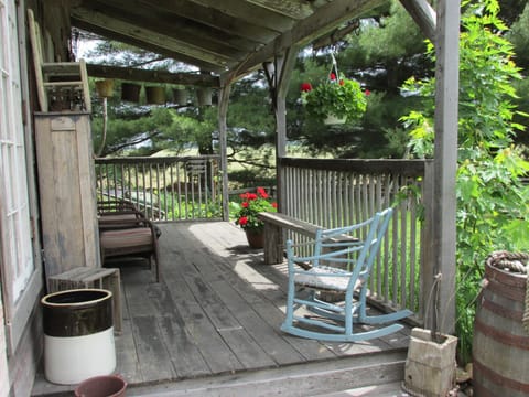 Dancing Fox porch with old wooden horse stall dividers for railings and more