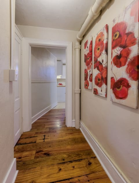 The hallway to the kitchen has the same wide plank warehouse wood floors