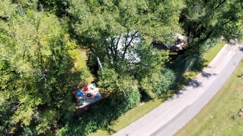 Paved road that leads to cabin with paved, covered parking and driveway 