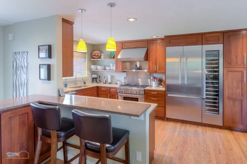 Gourmet kitchen opens to dining and living areas. 6 burner stove, warming shelf.