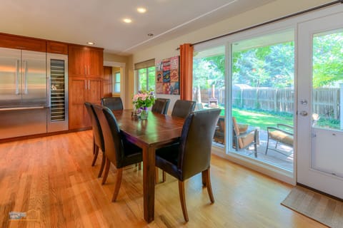 Dining area next to kitchen. Lots of natural light, seats 8.