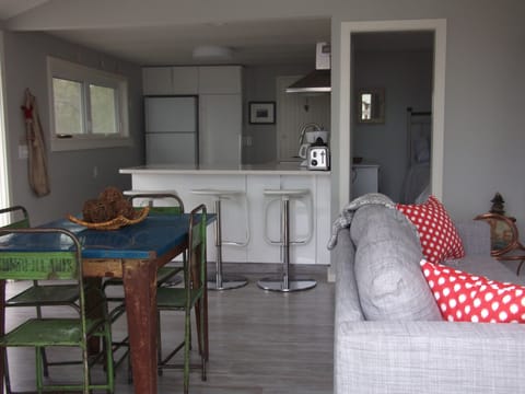 Kitchen, dining area, part of the living area and view into bedroom