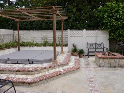 Backyard has a large spa, a gas fire pit and lots of seating