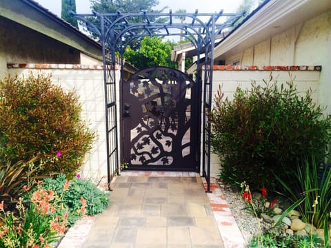 Beautiful gated entry into courtyard and front door