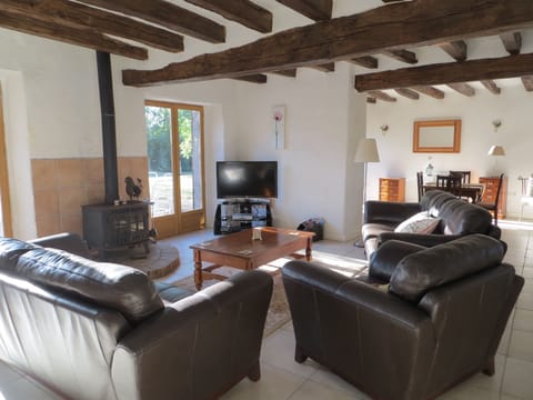 Beamed and spacious lounge with leather sofas, Plasma TV and log burning fire.