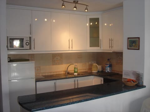 Kitchen with fridge freezer, microwave, oven and ceramic hob and washing machine