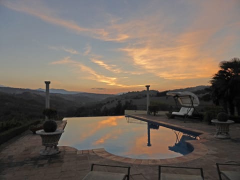 An infinity pool, a heated pool, sun loungers