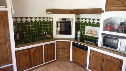 Provencal kitchen, ceramic hob and eye level oven and sink