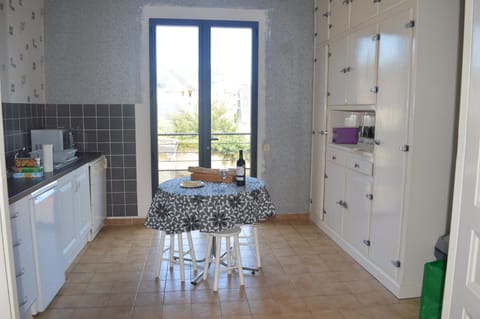 The kitchen leads out to a small balcony and steps down to the garden