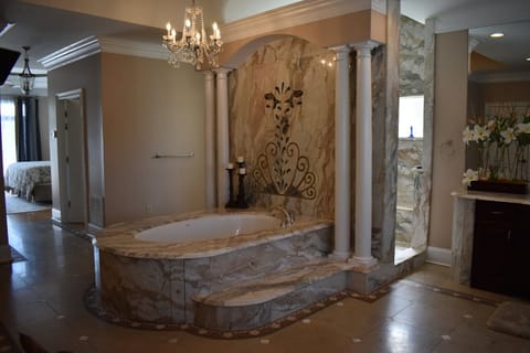 Primary bath #1 with beautiful stone designs, jet tub and walk-through shower.