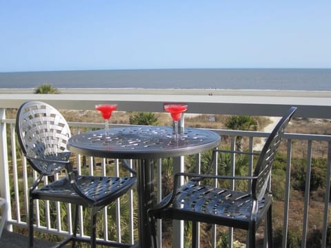 Relax and enjoy the ocean view from our private balcony table or lounge chair 