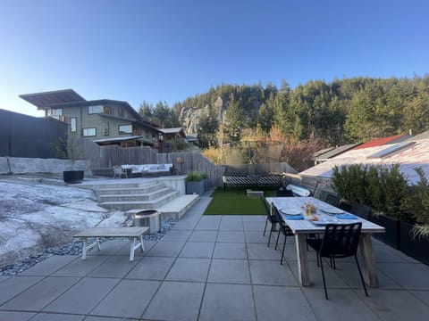 Gorgeous backyard with incredible views of Smoke Bluffs, trampoline and fire pit