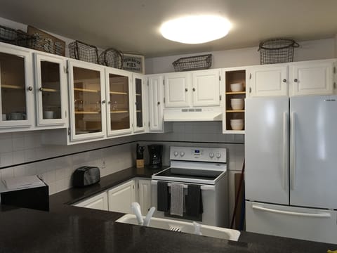 A nicely stocked kitchen. Blender, microwave, Kuerig, all you would expect