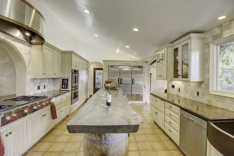 Chef's kitchen featuring Wolf stove, double oven, commercial fridge system