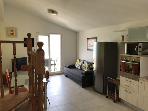 Living & kitchenette, with view to see, through a terrace