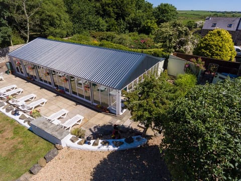 Indoor heated swimming pool from above with loungers