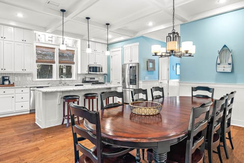 Spacious kitchen and dining area with table for 8 guests, breakfast bar seats 3 additional guests