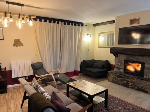 Lounge with log fire, double doors opening onto covered patio dining area.