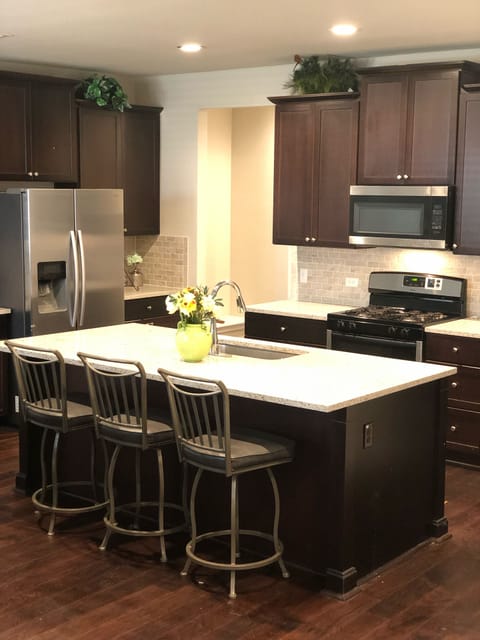 Kitchen w/ gas stove and stainless steel fridge