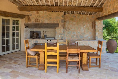 Outdoor dining room next to pool w/ fireplace and BBQ comfortably seats 10.