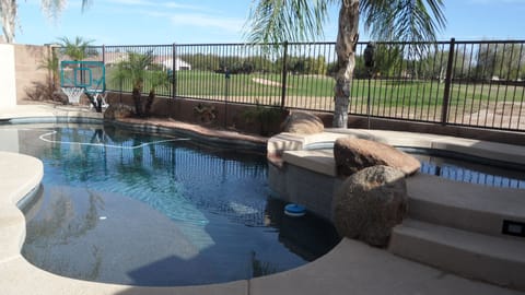 Heated pebble tec pool with golf course view.
