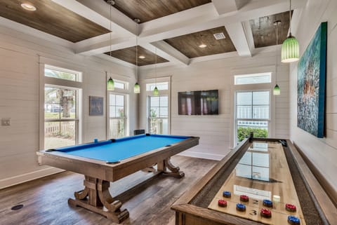 Pool table and shuffleboard table in main living room, french doors to pool