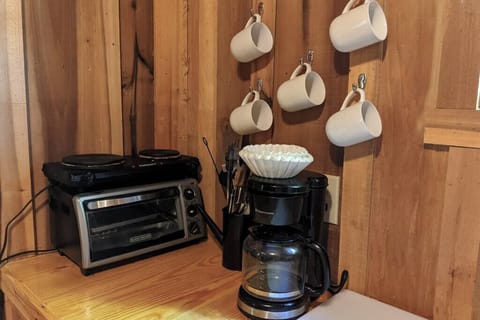 Coffee pot, cups, 2 burner stovetop and toaster oven.