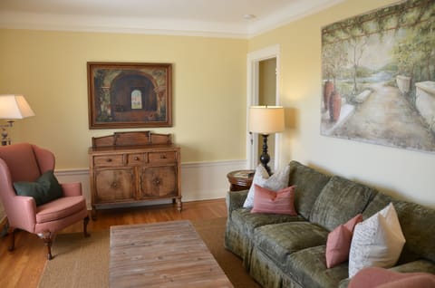 Living room with Mitchell Gold sofa sleeper, custom furniture & original artwork