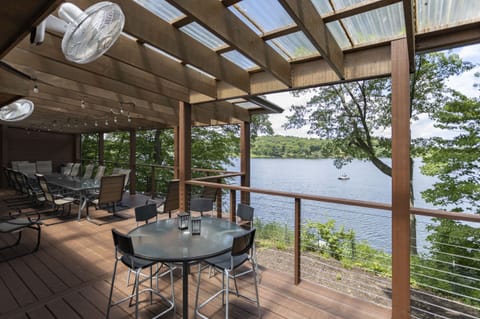 Covered deck overlooks Stone Lake, perfect for comfortable meals outdoors!